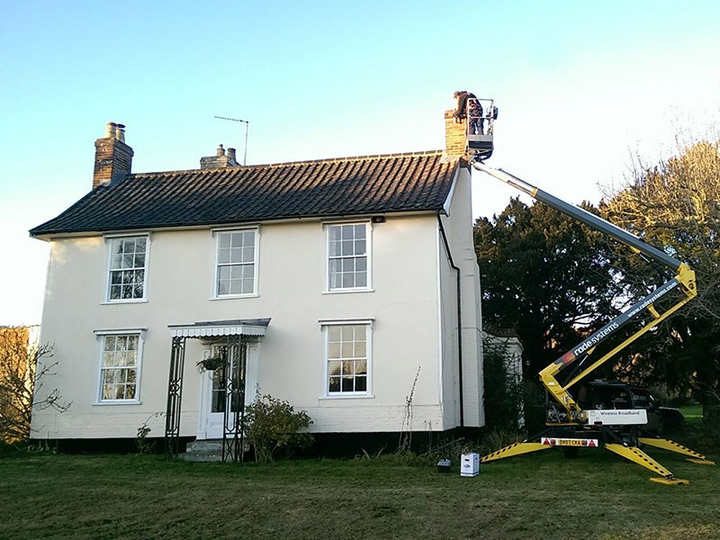 House with cherry picker mounting antenna